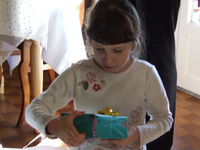 Louise opens a gift.