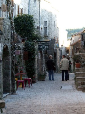 Rill and Criag walk down a street.