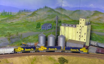 Passing the grain silo in a corner of the layout