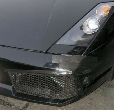 Front left of priceless Lamborgini with 10 cent tape repair on bumper.