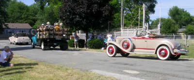 The Packard band and Rex's roadster lead off the parade