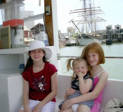 Little people passing a tall ship