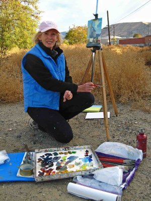  Artist Painting Old Grain Silo Near RR Tracks.