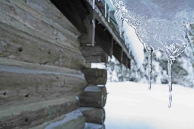 Ice Hanging Off Old Log Cabin