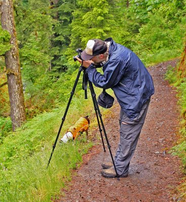 Deems Adjusts Tripod As Kelly ( His Dog) Stays Busy Exploring