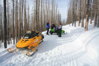  Snowmobilers Rest After Pulling Green Artic Cat Out