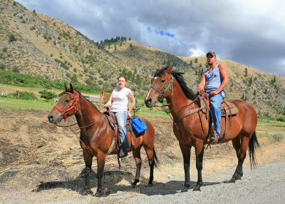   Young Couple Ride Their Horses Down  Sleepy Entiat River Road