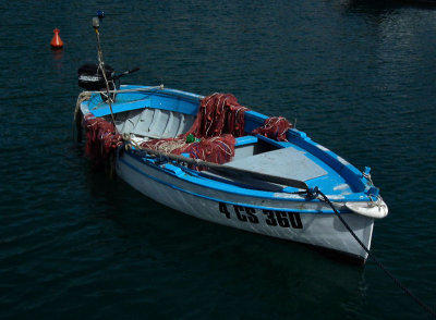 Blue and white dinghy with red nets Seiano