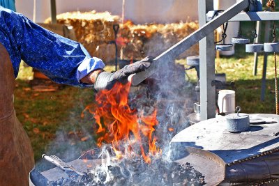 Blacksmith With Hand To His Bellows