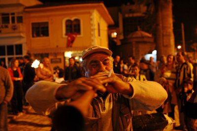 An Old Man Celebrating On His Horn