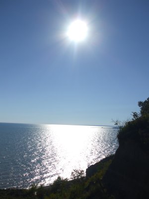 Sun shining down over cliff.JPG