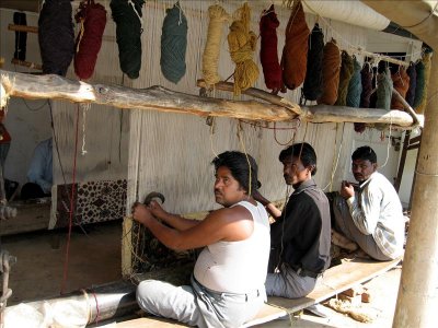 Carpet weavers demonstrating tying techniques