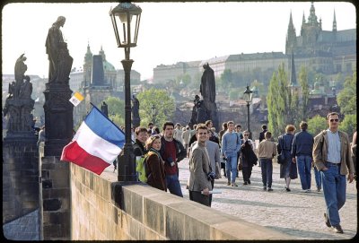 Spring in Prague on Charles Bridge Papal flags visible proud people
