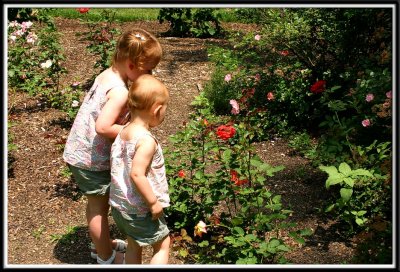 Noelle and Kylie sniff the roses