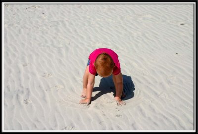Kylie inspects the sand for any impurities
