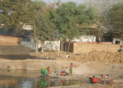 Women and girls washing, early morning