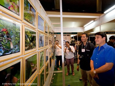 A WALL OF ENDEMIC BIRDS. Congressman Miguel Zubiri of Bukidnon views endemic bird photos exhibited by the Philippine Bird Photography e-Group (PBPeG), 
as bird shooter Nilo Arribas looks on and Lydia Robledo shoots some pics in the background.