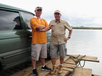 A RACER AND A BIRDER. My brother Jeff (left) ably piloted our birding vehicle, as he made the over 500 km trip to Malasi Lake in just under 10 hours, including wading through heavy traffic along the way. 
Here, Jeff and birding buddy Neon pose by our car while we cross the mighty Cagayan river aboard a makeshift raft.