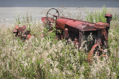 Rusty Tractor beside Building