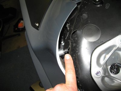Stud in side panel goes in grommet in tank