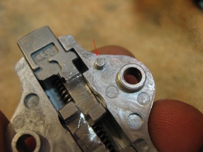 Notice that the small stud lines up with the hole below when reassembling latch