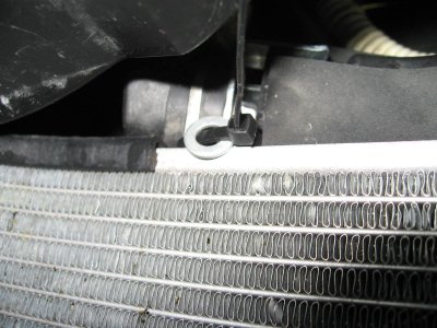 Tip tie in position around top radiator mount