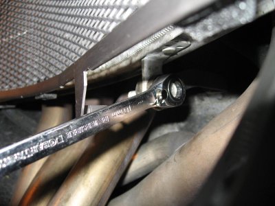 Remove bottom bolt radiator bolt and put it through the mount point in the grill