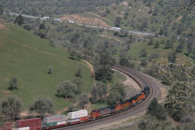 Four eighteen wheelers on highway 58 and 18 wheel trailers on the train !!!