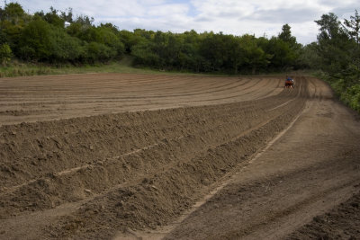 West over farm: ploughing the field