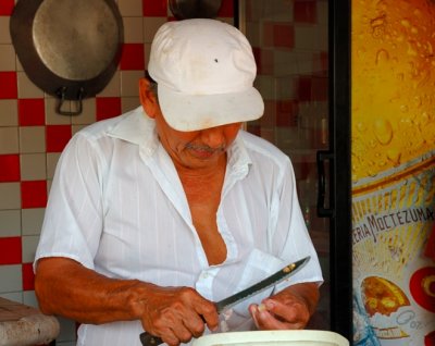 Pollo Man Cutting Garlic