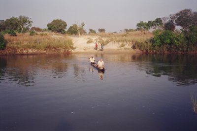 Crossing the river with my bike in a dugout canoe.JPG