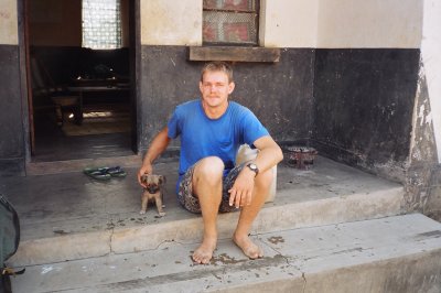 Fred on his front porch with his puppy.JPG