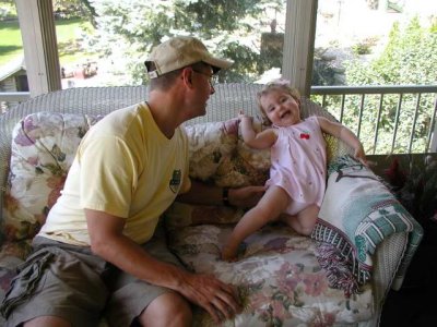 the girl is climbing next to daddy