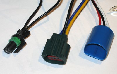Conversion harness for head and foglights. The blue connector to the factory '04 plug. Black to '05 headlight, green to fogs