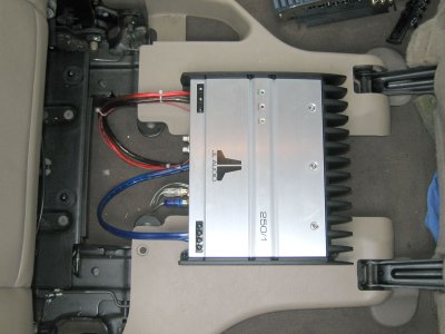 JL Audio 250/1 Sub amp. The 2nd row captain seats slide forward to reach the 3rd row seat. Wires can slide forward with amp.