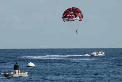 Some parasailing activity offshore.