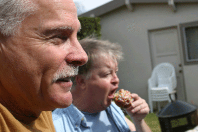 Lee gazes while Chaz unhinges his jaw to ingest a sphere of Carbo-Chud