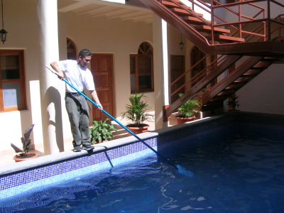 Jose cleaning the pool