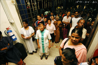 a priestess from nearby Chinese temple in the anticipating crowd