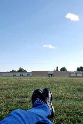 Laying in Ditch looking at school bldg