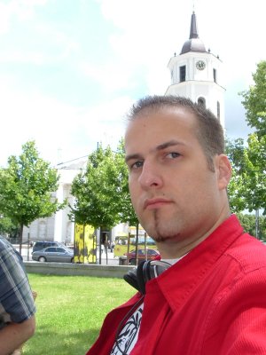 Me at a cafe in Vilnius with a stunning church in the background