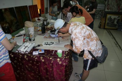 Young artists producing paintings for tourist market.