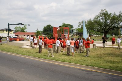 Harris Students at 9th ward Memorial, Blue pylons show the depth of floodwaters