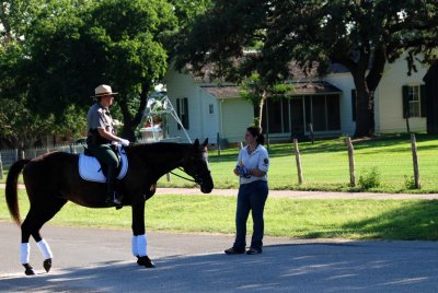Park Ranger with LBJ's boyhood home in the background