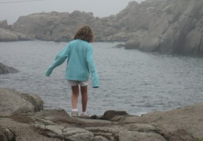 girl  on rocks at nubble lighthouse