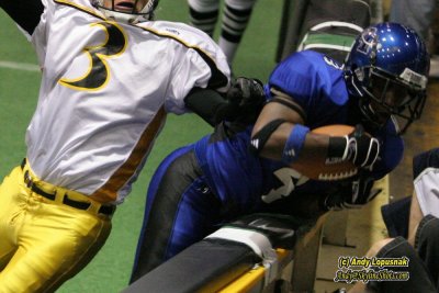 Michigan Pirates RB Robert Height gets slammed into the boards after a touchdown