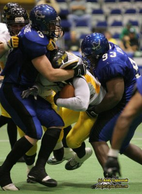 Michigan Pirates linemen Jeff Dembowske and Eddie Bynes combine on the tackle