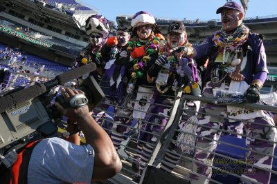 Baltimore Ravens fans with CBS cameraman Larry Frazier