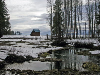 A ranch in Ft. Klamath on a cloudy day. Spring is on the way. The snow is melting and Lost Creek isreflecting the trees.