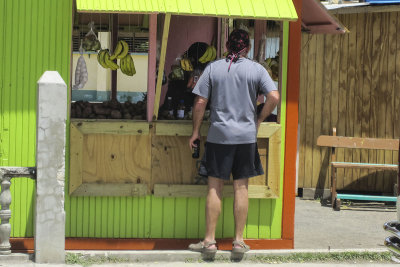 Redbeard buying bananas in his crocs, Hillsborough, Carriacou